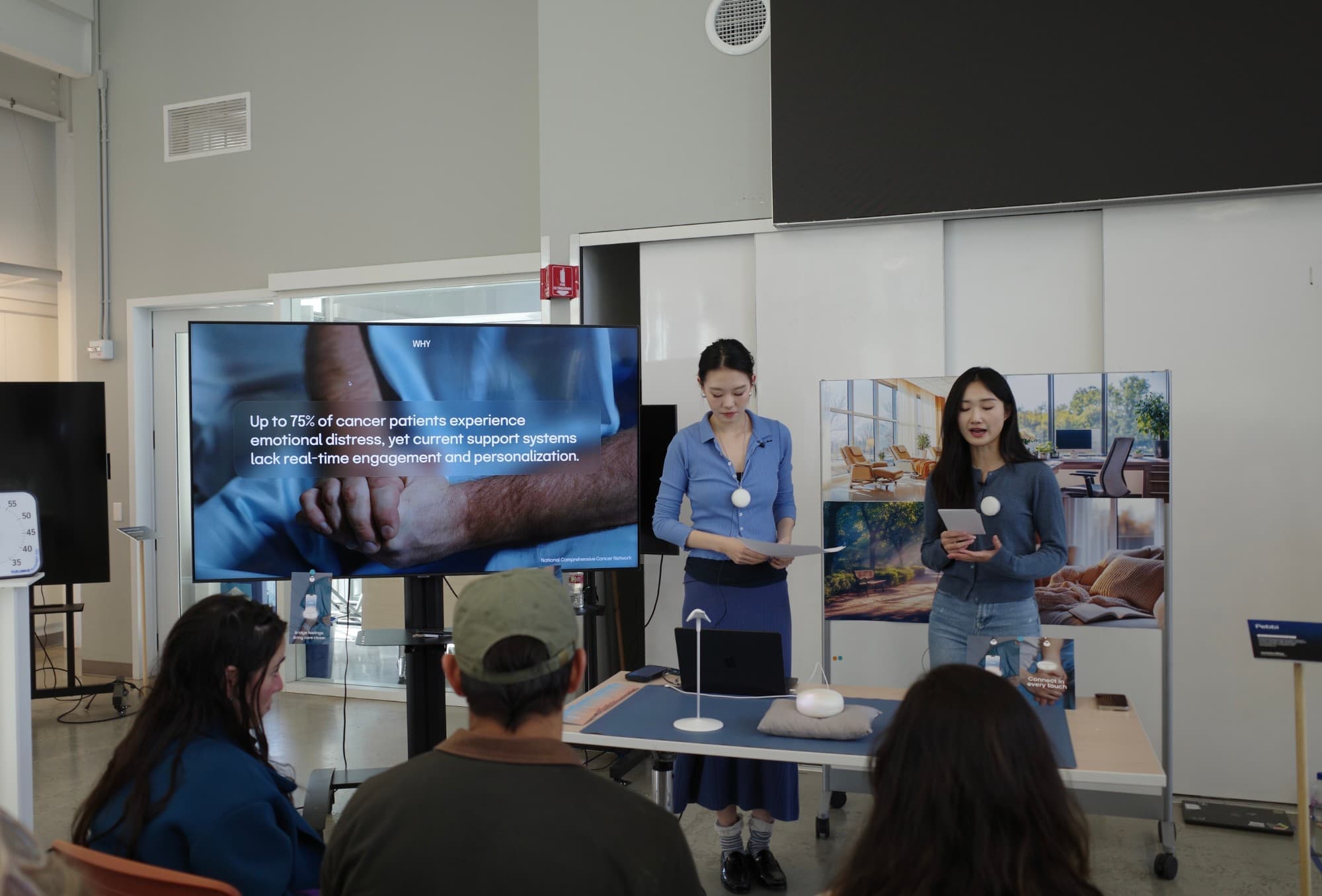 Presenting Pebbi at the graduate showcase, with the device on a small table in front of the audience